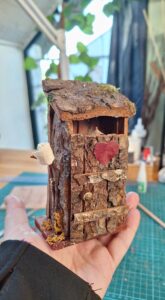 miniature toilet finished closed on hand